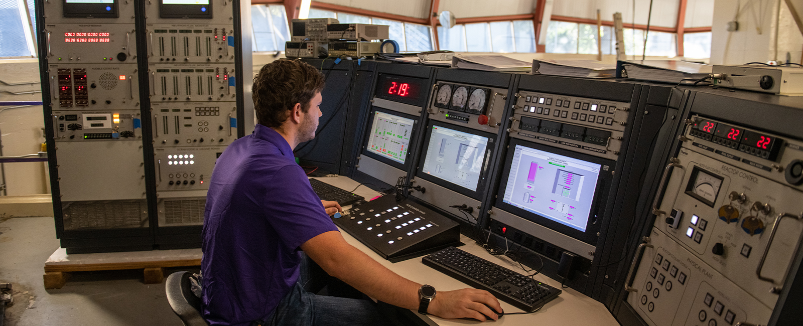 Student sitting at the nuclear reactor control panel